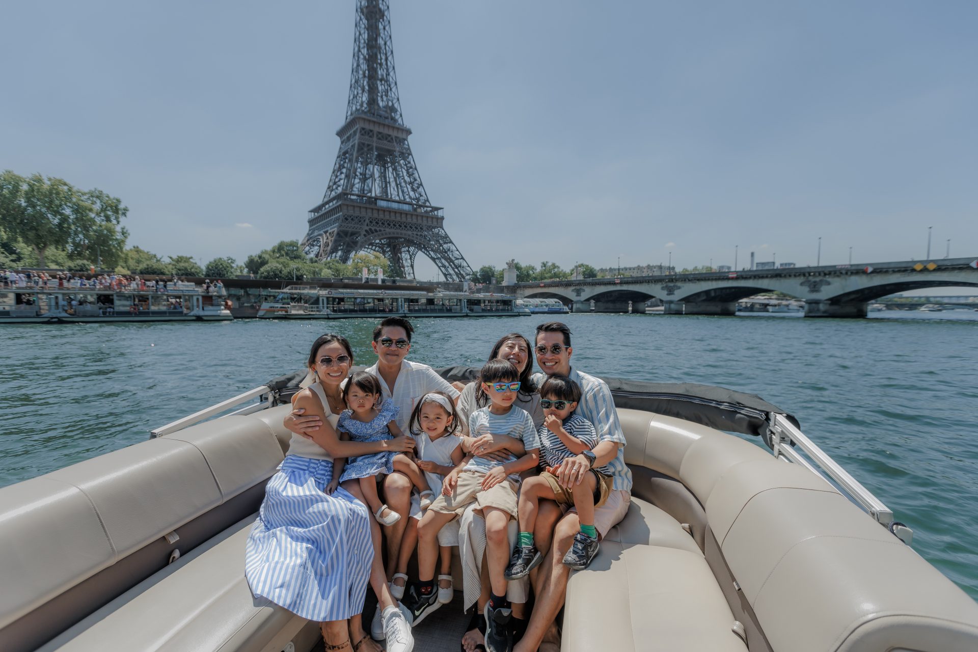 Family on a My Paris River boat in front of the Eiffel Tower